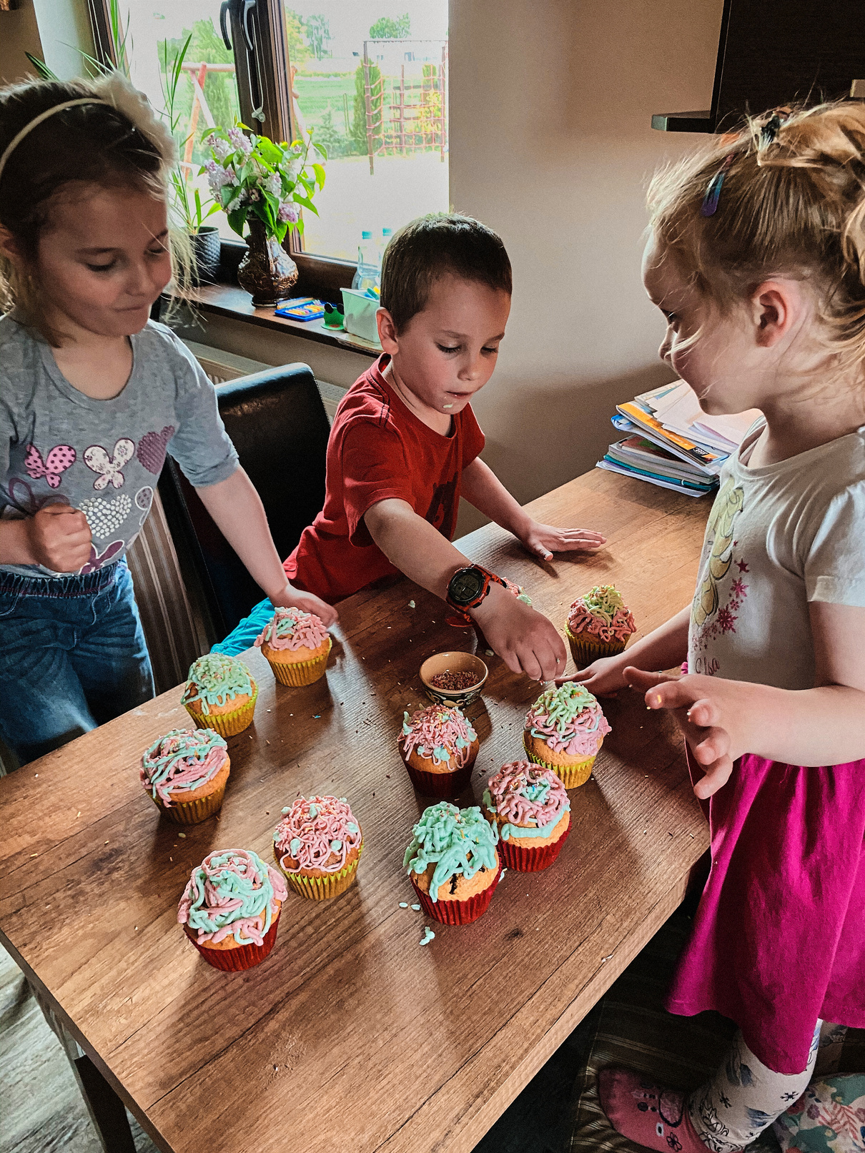 Kids Decorating Cupcakes with Sprinkles 